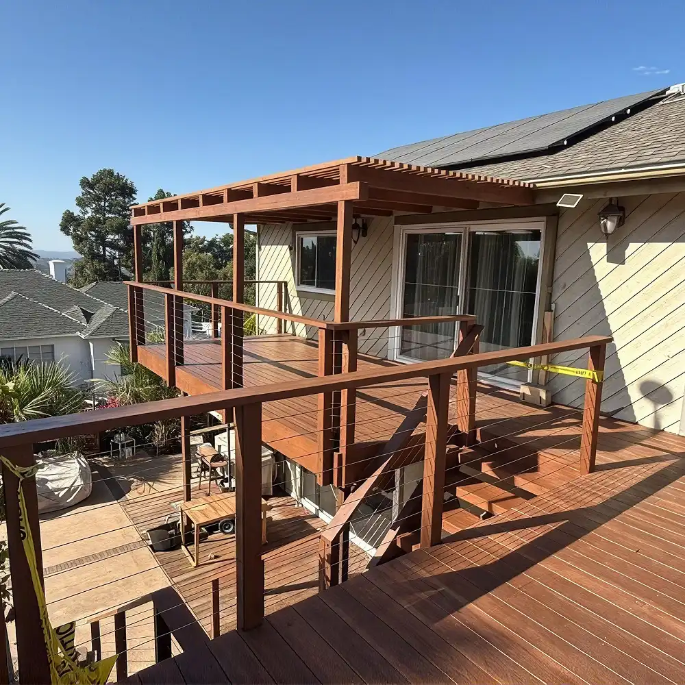 Multi-level composite deck with integrated pergola and horizontal railing built by Kan Builders in San Diego