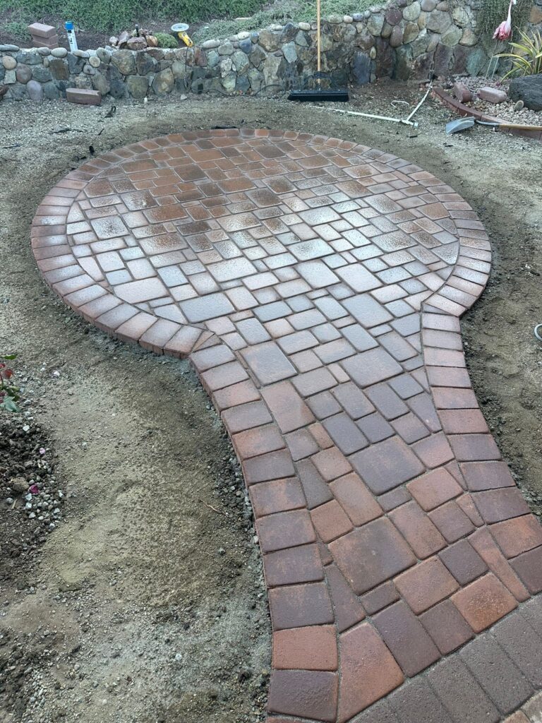 The Sloped Sanctuary — Custom Paver Hardscape Installation