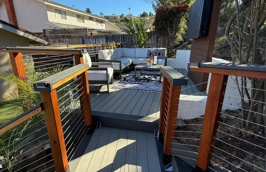 Composite deck with cable railing and outdoor lounge seating