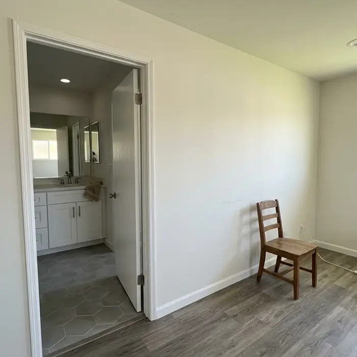 Bathroom adjacent to a bedroom in a whole home remodel