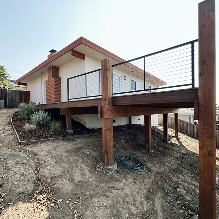 Elevated post-and-beam hillside deck on a sloped lot