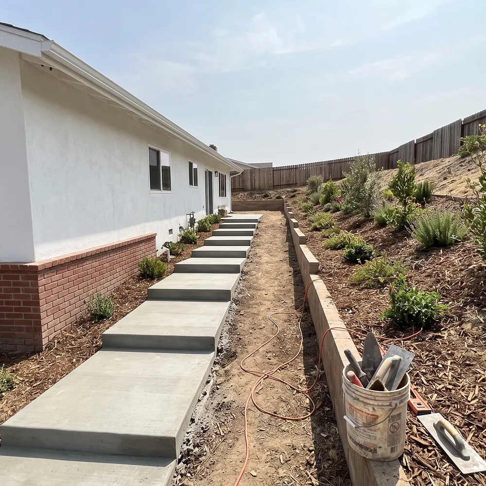 Backyard remodeling project in Chula Vista with a covered patio, outdoor seating, and drought-tolerant landscaping