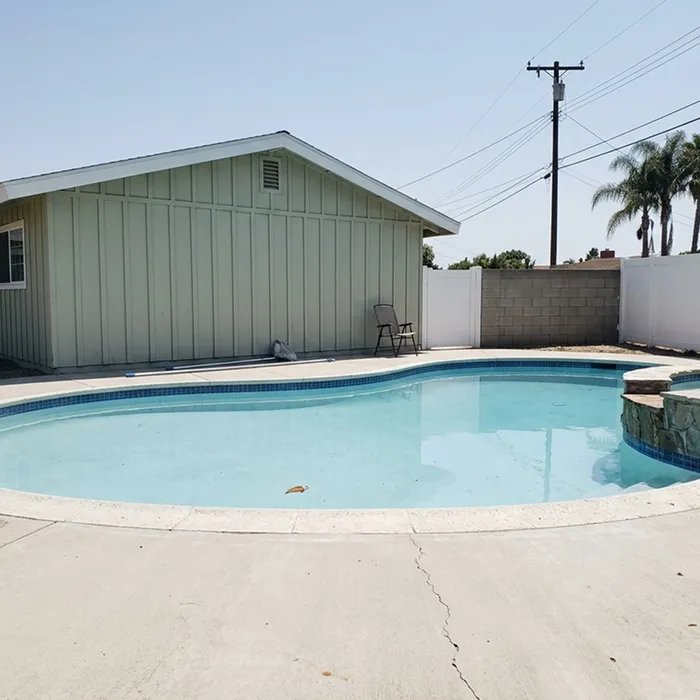 Pool and spa with a concrete pool deck