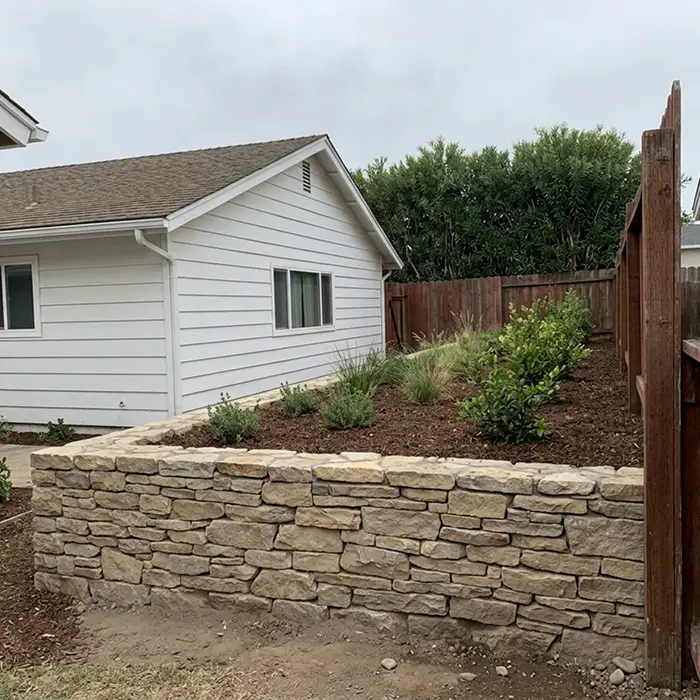 Stacked natural stone retaining wall