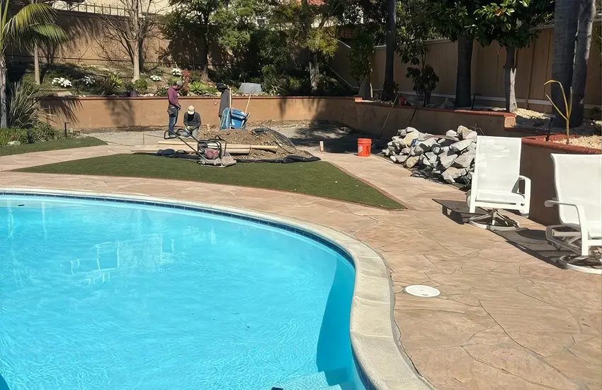 Stamped concrete pool decking with in-ground pool