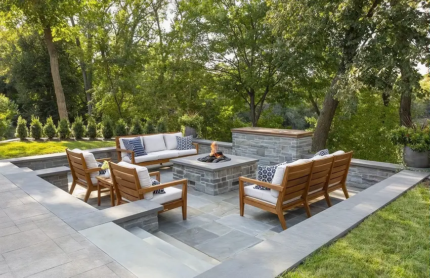 Sunken bluestone patio with stone fire pit and lounge seating