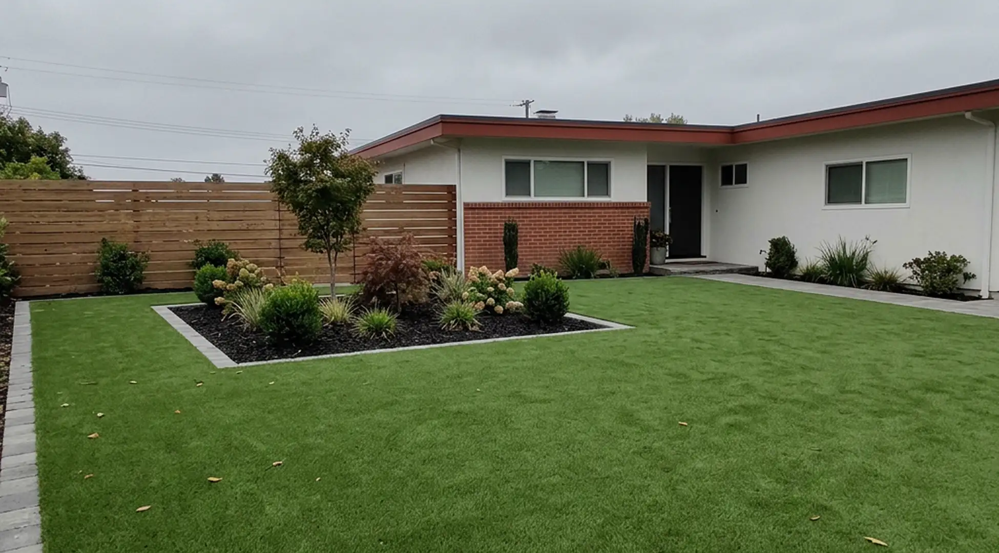 Finished front-yard landscaping with drought-tolerant planting beds and a decomposed-granite path